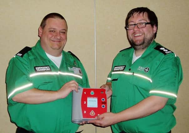 Volunteers Colin Jameson, left, and Andrew Horsley with a new defibrillator.