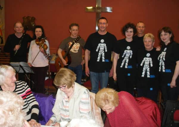 Susan Hewitson and family with prostate cancer T-shirts, who organised a ceilidh in aid of Prostate Cancer UK in North Street Methodist Church, Silksworth, and also members of the band.