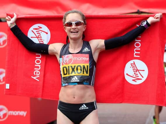 Aly Dixon celebrates after being the first British woman over the line in today's London marathon, which qualifies her for the Rio Olympics.