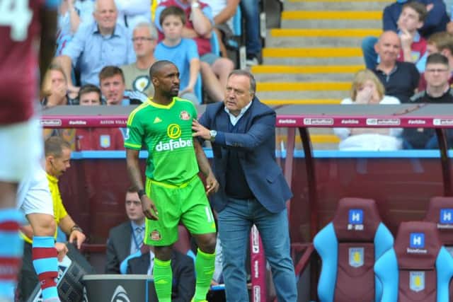 Jermain Defoe receives instructions from former manager Dick Advocaat
