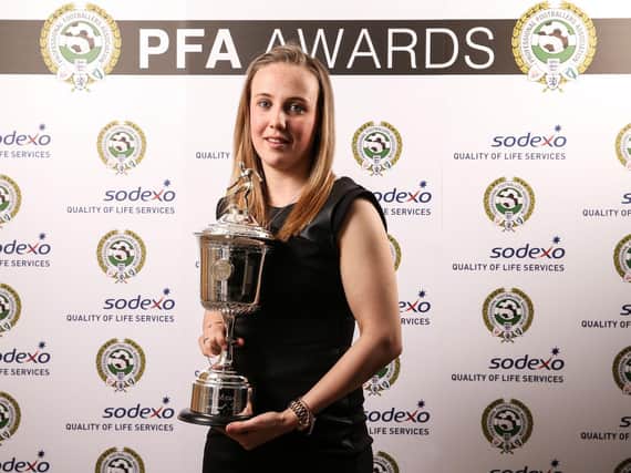 Beth Mead celebrates with her award