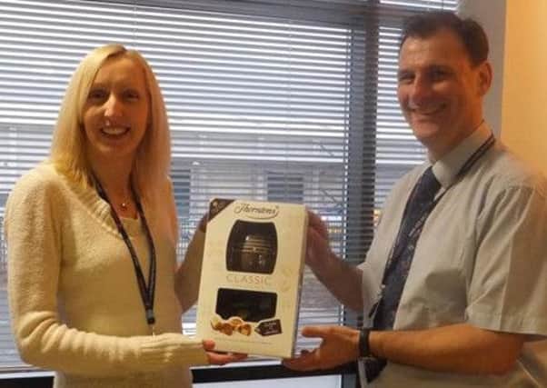 Rhonda Pickering, Communications and Marketing Officer for East Durham Homes, presents a raffle prize to one of the lucky winners, Peter Eldrett, Customer Involvement Manager.
