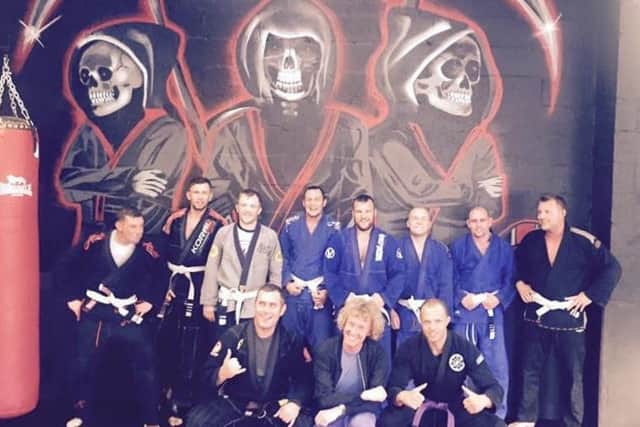 Grayson Perry, centre front row, with cage fighters at Made 4 the Cage in Southwick.