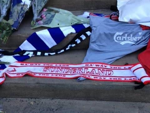 Teacher Peter Hull also placed a Sunderland scarf at the steps of St George's Town Hall, which has become a focal point for tributes.