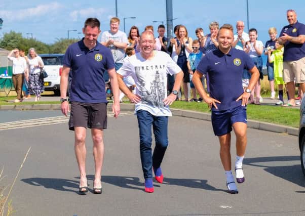 Gavin McGough, Andy Doncaster and Marc Penprase take part in last summer's sponsored walk in high heels in aid of Seaham Coast FC.