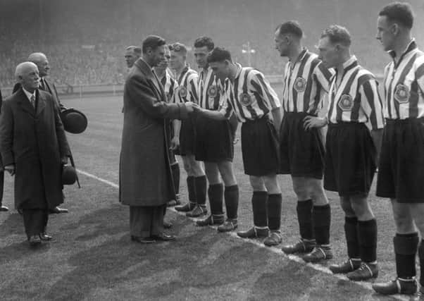 Sunderland skipper Raich Carter presents his team to King George VI before the match.