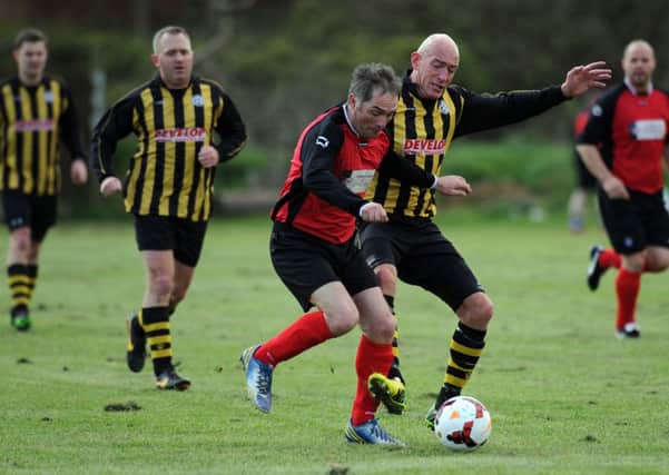 Over 40's football action in the Alan Spedding Cup Final between Dubmire WMC (yellow black) and Heaton Stannington, played at Wearmouth CW
