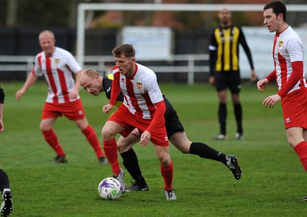Ryhope CW (red and white) battle against Hebburn Town last weekend