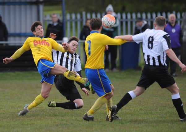 Boldon CA (stripes) battle to victory against Stockton Town in last weekend's Shipowners Cup semi-final. Picture by Tim Richardson
