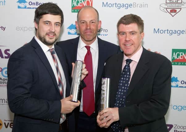 Phil Spencer, centre, presents awards to Bill Free Homes Sean Lawless, left, and Peter Smith.