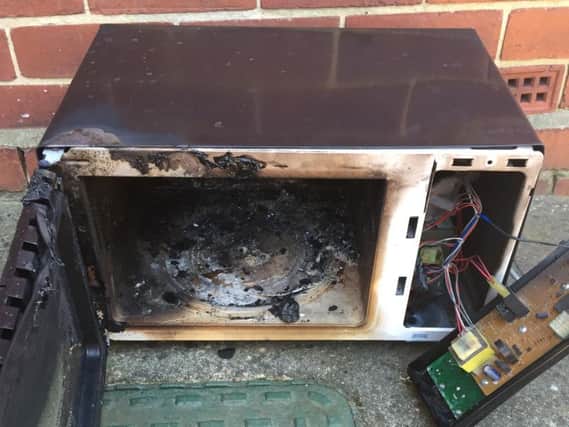 The microwave which was wrecked by fire.