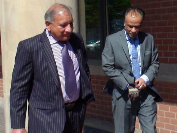 Restaurant owner Mohammed Zaman (right) leaves Teesside Crown Court, as Mohammed Khalique Zaman, 53, an Indian restaurant owner who is going on trial today accused of the manslaughter of a customer who suffered a fatal allergic reaction to peanuts after eating a takeaway curry. Picture by PA.