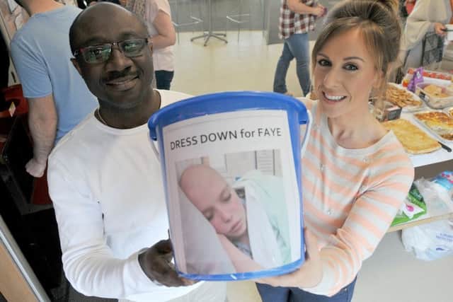 EDF workers Emmanuel Asante-Akufo and Jenny Scholes with their collection bucket  to help Faye Thompson.