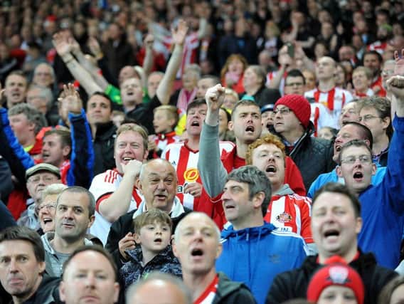 Sunderland fans celebrate their team beating Everton to secure Premier League safety.