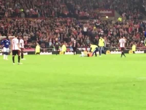Stewards remove a pitch invader at the Stadium of Light during the Sunderland v Everton game