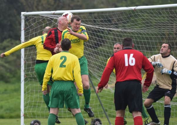 Blue House (red) attack the Wallsend Winstons goal in last week's Over-40s Echo Cup final.