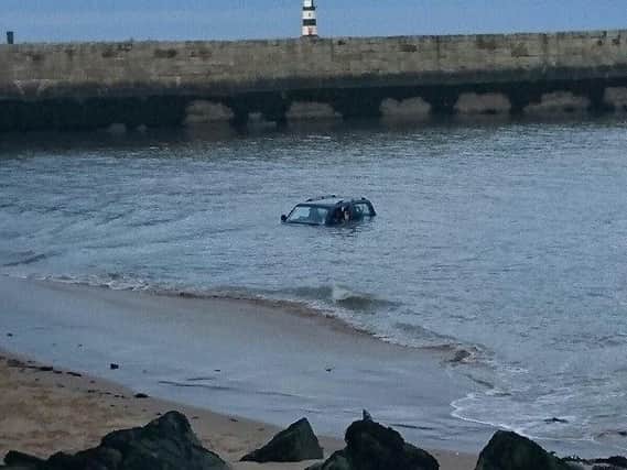 The vehicle partly submerged off the shore at Seaham Marina.