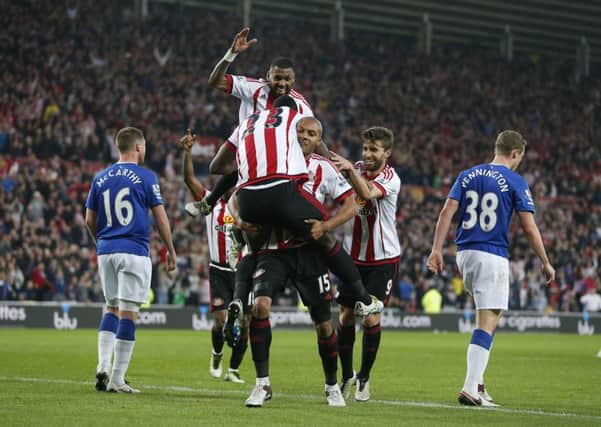 Sunderland's Lamine Kone celebrates scoring his side's third goal of the game with teammates during the Barclays Premier League match at the Stadium of Light on May 11.
