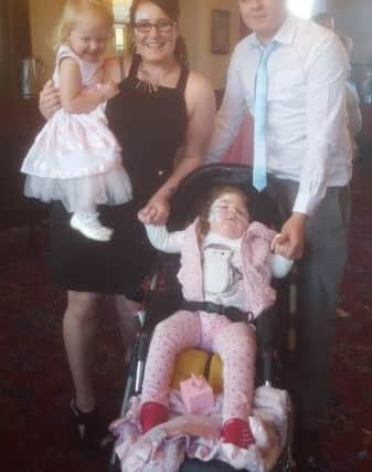 Lillia Merrington with little sister Talia, dad Josh and mum Simone Clark.