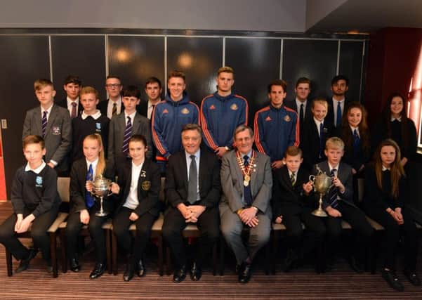 The captains of Sunderland Schools FAs trophy-winning teams join up with Sunderland players Tom Beadling, George Brady and Carl Lawson (back), plus councillor Mel Speding and SSFA chairman  Aidan Tasker (front).