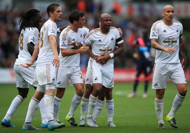 Swansea City's Andre Ayew (second right) celebrates with teammates