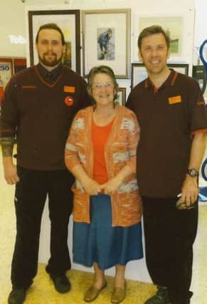 Sylvia Hurst, of Silksworth Art Group, with members of Sainsbury's staff.  The store held an exhibition jof the group's work.