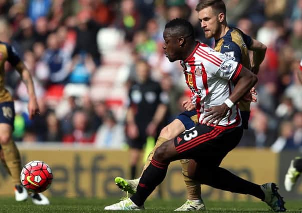 Sunderland's Lamine Kone (left) battles for the ball with Arsenal's Aaron Ramsey.
