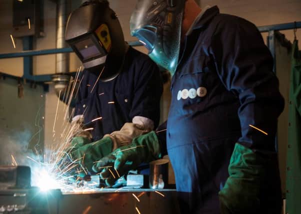 Gary Corner, specialist welding instructor at Seta (right) works with a student.