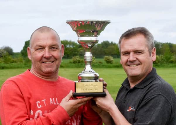Getting reday for the Mark Dixon Memorial football match, between Belle Vue Old Boys and Sports Bar are Gary Horton (left) and Mark Sickling