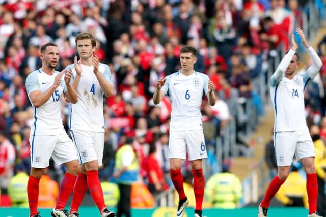 (left to right) England's Danny Drinkwater, Eric Dier, John Stones and Jordan Henderson celebrate victory after the international friendly match at the Etihad Stadium, Manchester.