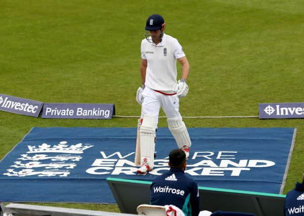 England's Alastair Cook walks off the field after being out for 15 at the Emirates Riverside