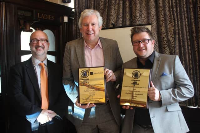 (from left) Dr Steven Parissien presents the Camra awards to Paul Callaghan, of the Mac Trust, and Dun Cow manager Chris Wright.