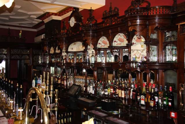 The historic wooden bar back of The Dun Cow.