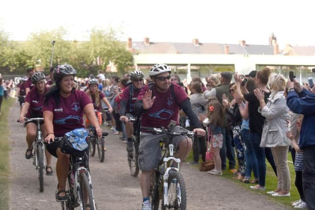 Tom and Carla Cuthbertson leading the cyclists of the Cuthy's 200 Bike Ride into Ashbrooke Sports Ground last year