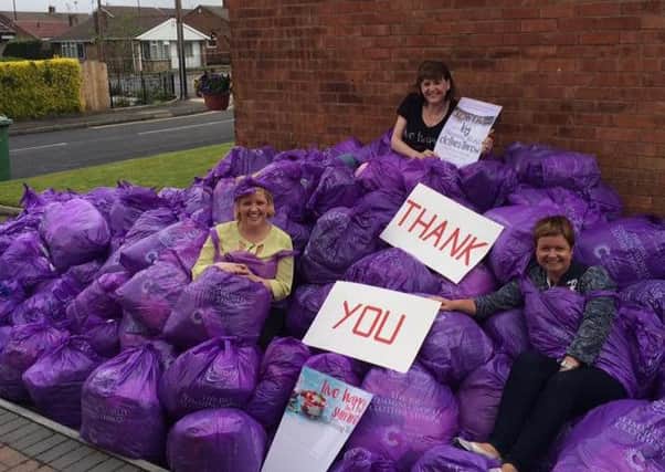 Slimming World Sunderland team developer, Julie Mulvaney with consultants, Joanne Miller and Janice Webster waiting with just some of the contribution ready for collection.