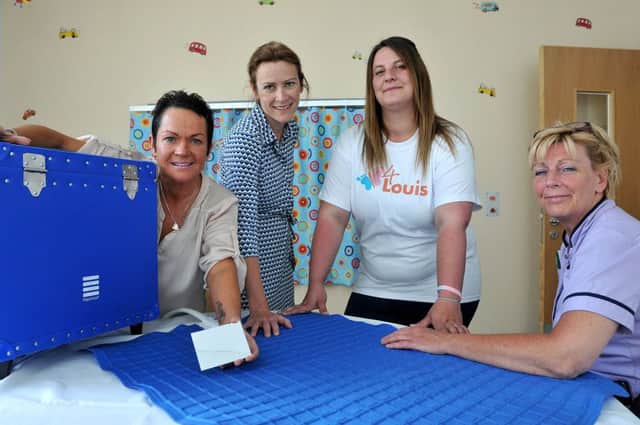 Photographed with the donated cuddle blanket are (left to right) Julie Reay, Alison Guadagni consultant Paediatrician (great north Children's hospital) , Kirsty McGurrell (4Louis) and Helga Charters matron children services (great north Children's hospital). Photograph by FRANK REID