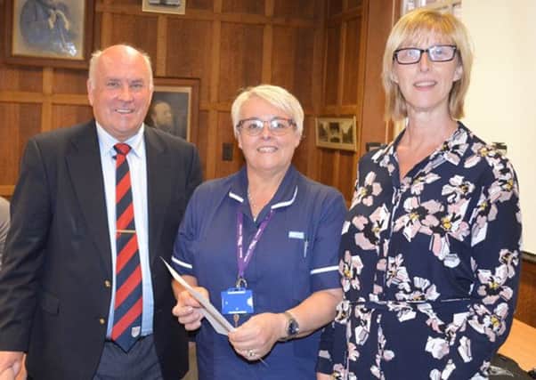 Wearside League chairman Peter Maguire presents a Â£1,000 cheque to the ward sister of Roker Ward at Monkwearmouth Hospital and hospital manager Helen Grey