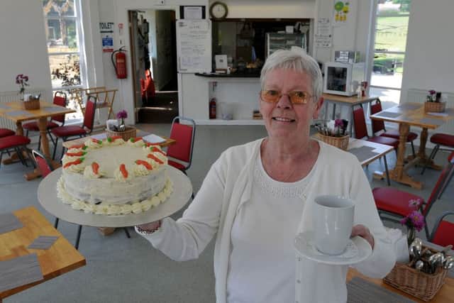 Norma Burnett volunteer at Bede's Bakehouse with cake and coffee.  Photograph by FRANK REID