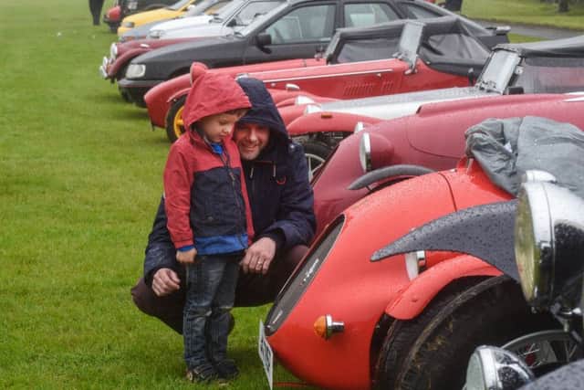 Glen Butler with his son Alfie (4) looking at some of the cars at the Sunderland & District Classic Vehicle Society annual show at Seaburn, yesterday.