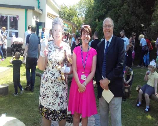 Coun Michael Dixon with teacher Catherine Scott and assistant headteacher Lesley Heron reminding everyone of the Queen's offical birthday, which took place that week, at Hill View Infant School.