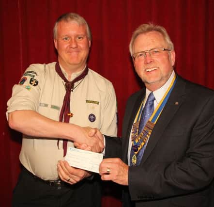 Rotary Club of Houghton President Bernard Blacklock presents a cheque to Paul Sutherland Group Scout Leader at 1st Houghton St Michaels Scouts.