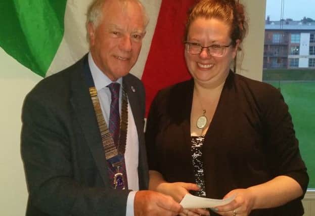 Corrine Kilvington, Artistic Director of Theatre Space NE, receives a cheque from Sunderland Lions Club.