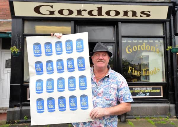 Artist Andrew Parkin with his EU Referendum debate artwork at Gordons Butchers.