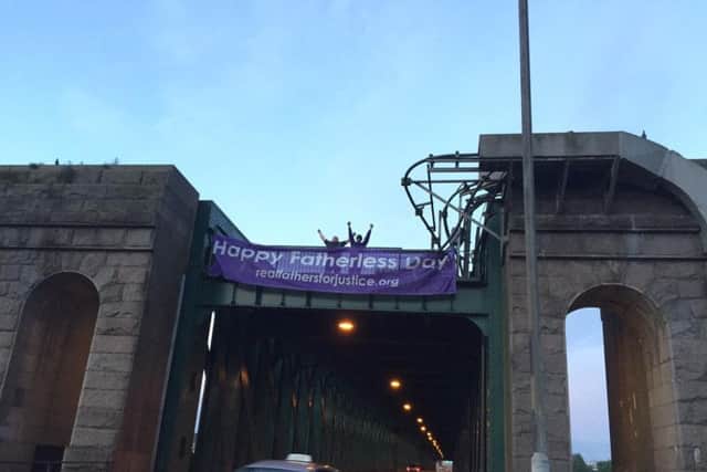 The protesters scaled the bridge early on Father's Day.