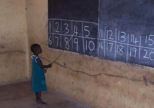 A child at a blackboard in one of the Wulugu Project schools.