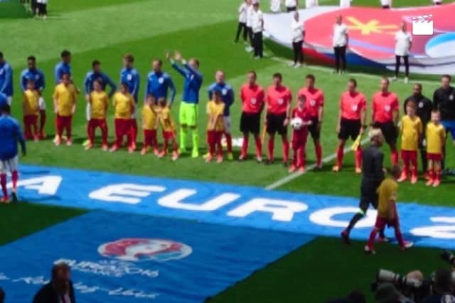 Theo Weiss, wearing red in front of match officials, ahead of kick-off in the England v Wales Euro 2016 game.