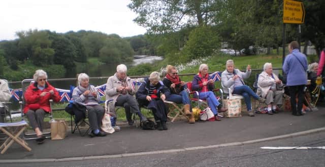 Members of the Wessington U3AWar Memorial group knitting poppies on Fatfield Bridge to remember the soldiers killed in the battle of the Somme.