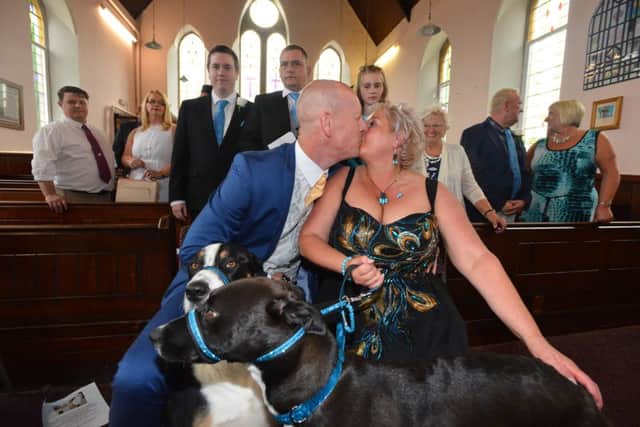 Clare and Mel Dixon renew their wedding vows with dog's Nettie and Oscar