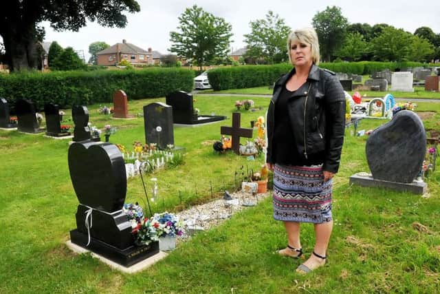 Julie Liddle at the grave of her parents.