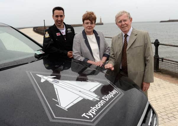 RAF Typhoon display pilot Mark Long with the RAF Typhoon liveried vehicle at Roker lighthouse with Sunderland Airshow Director Sue Stanhope and Sunderland City Council Deputy Leader Coun Harry Trueman.